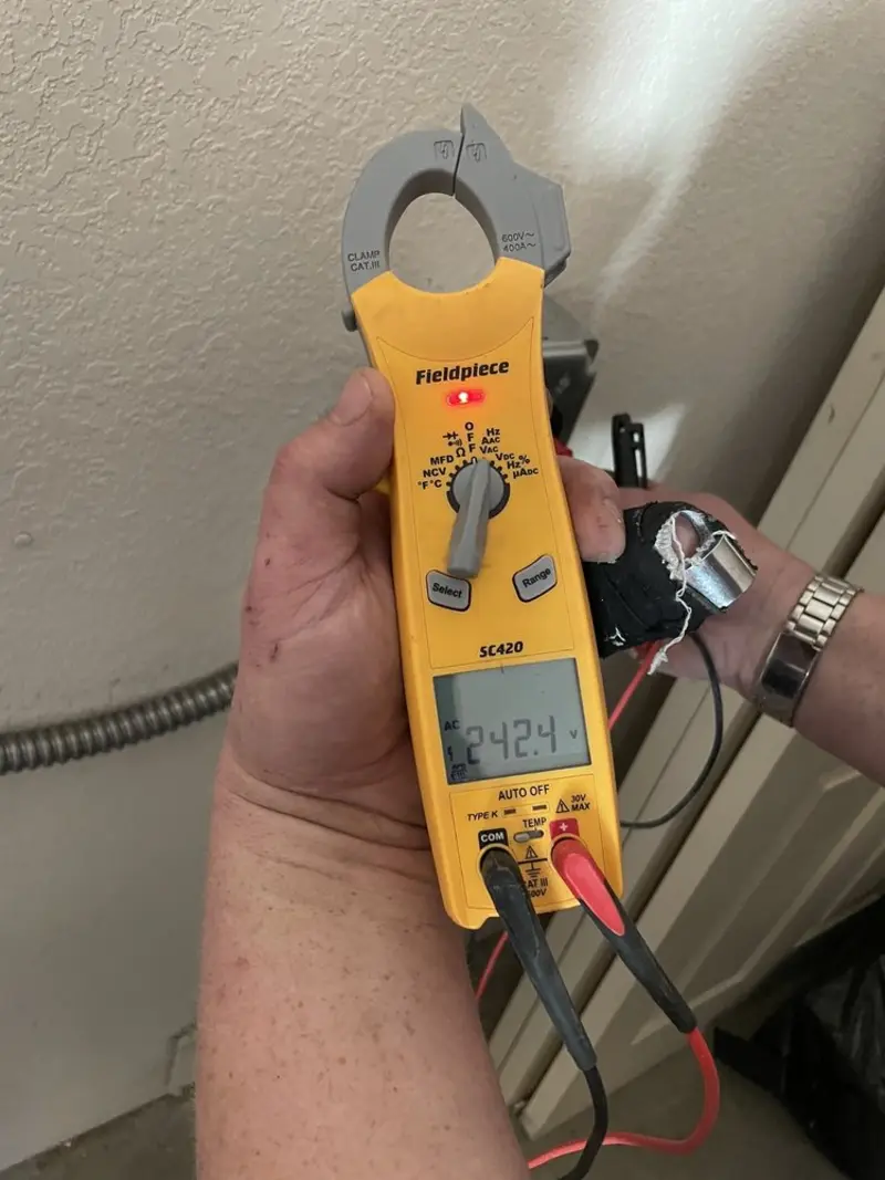 Voltage testing with clamp meter during Whole House Surge Protector in Norwell